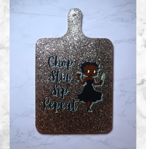 Handmade custom resin cutting board measuring 13 x 8 inches with decorative design